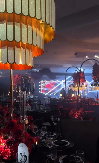 Deco chandelier over a candlelit banqueting room